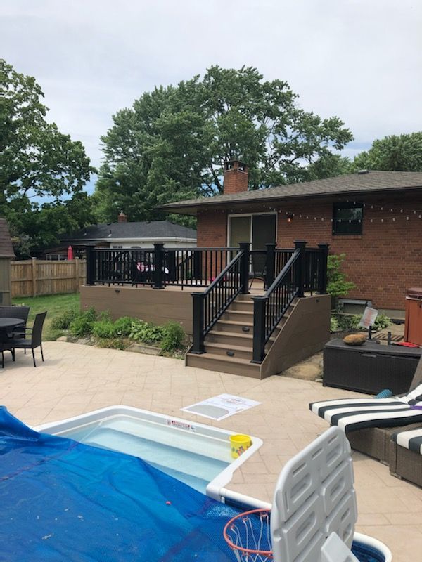 There is a swimming pool in the backyard of a house.