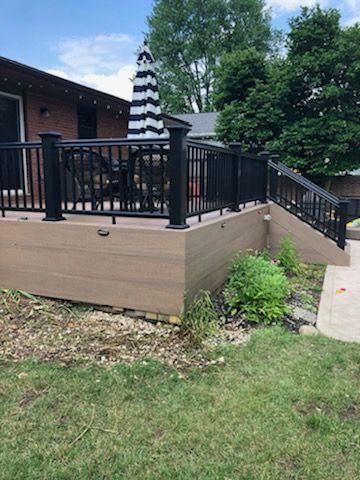 A patio deck with chairs and a bar.