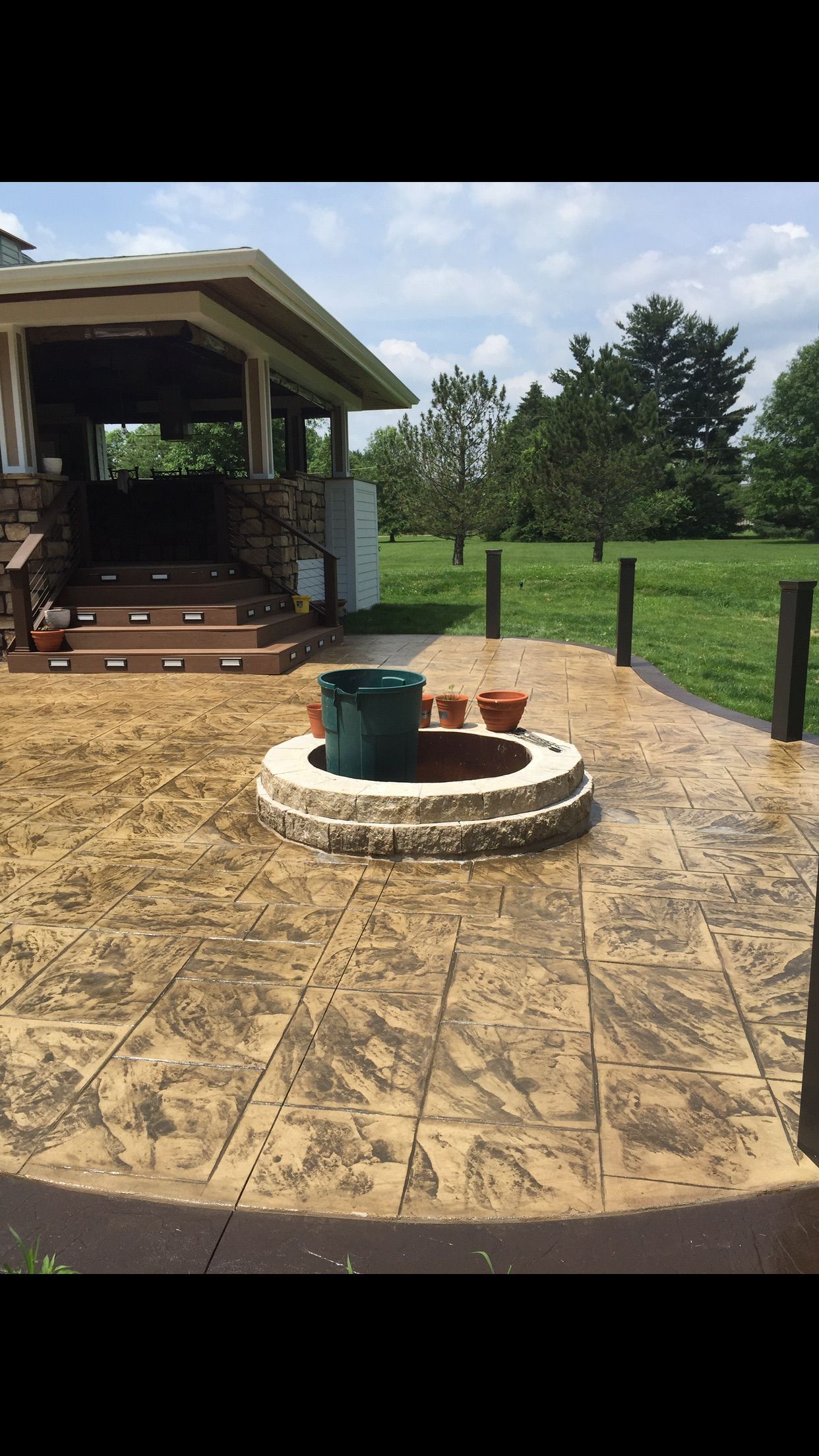 There is a fire pit in the middle of the patio.