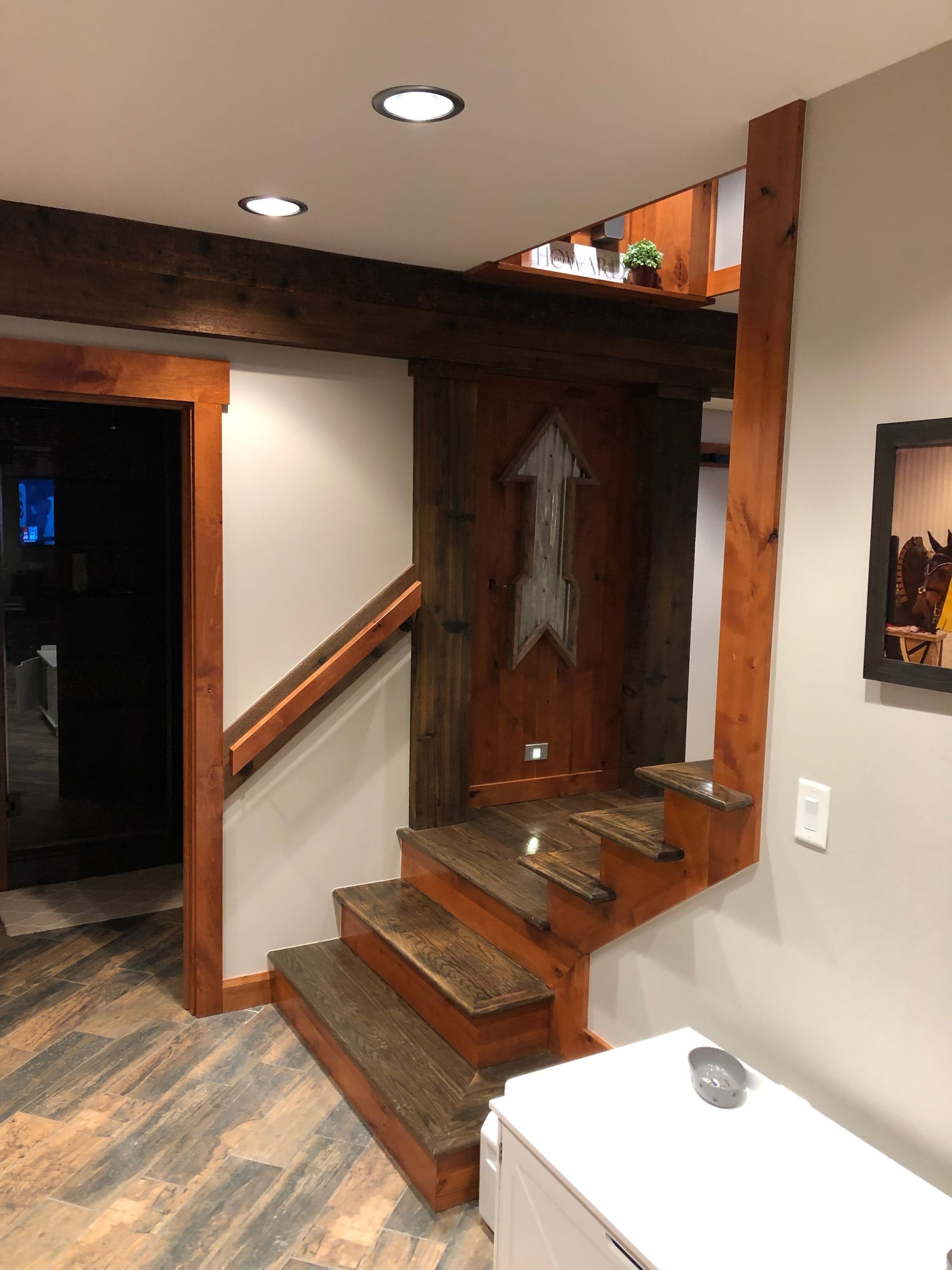 A basement with a table, chairs, and an arcade machine.