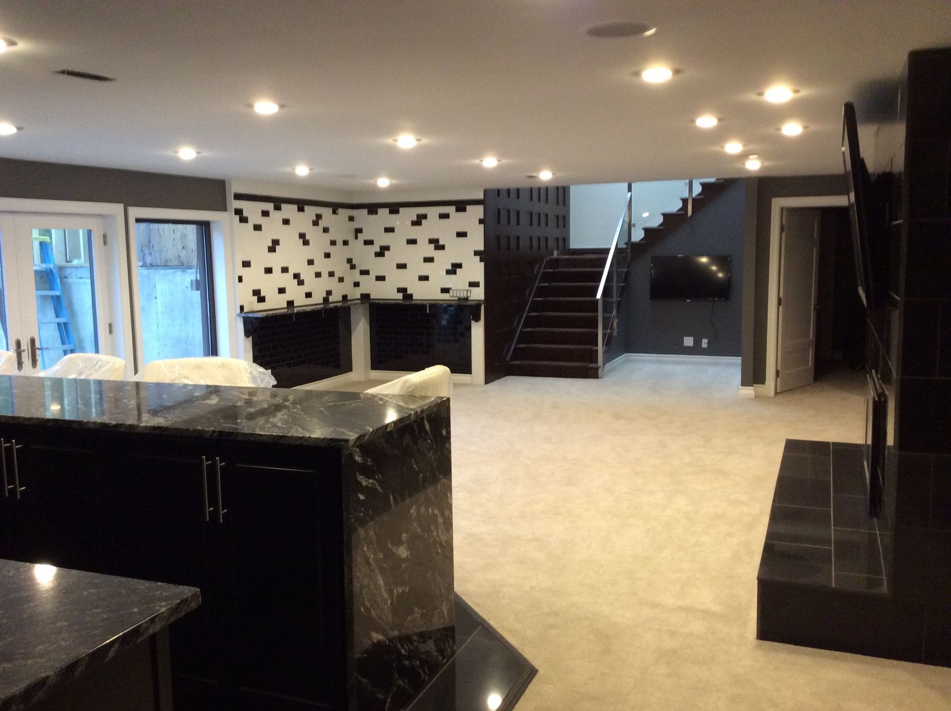A living room with a staircase leading up to the second floor.