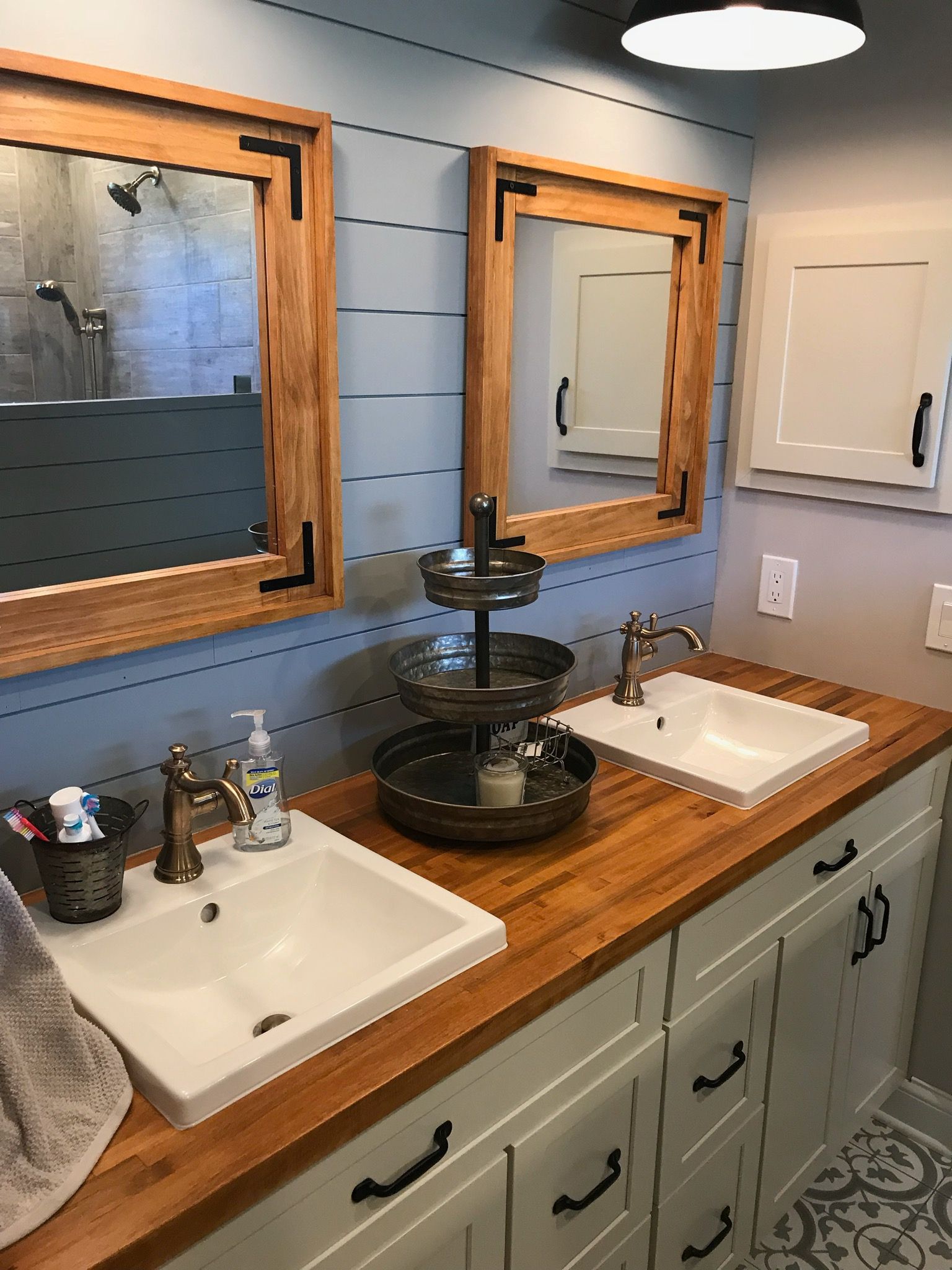 A bathroom with two sinks and two mirrors.
