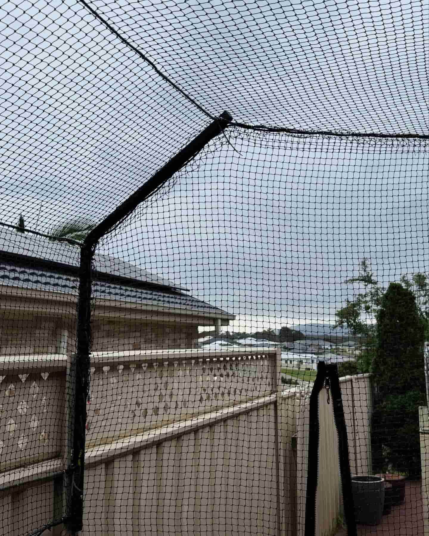 A Baseball Net is Sitting on Top of a Wooden Fence — Illawarra Gardening Landscapes in Canberra, NSW