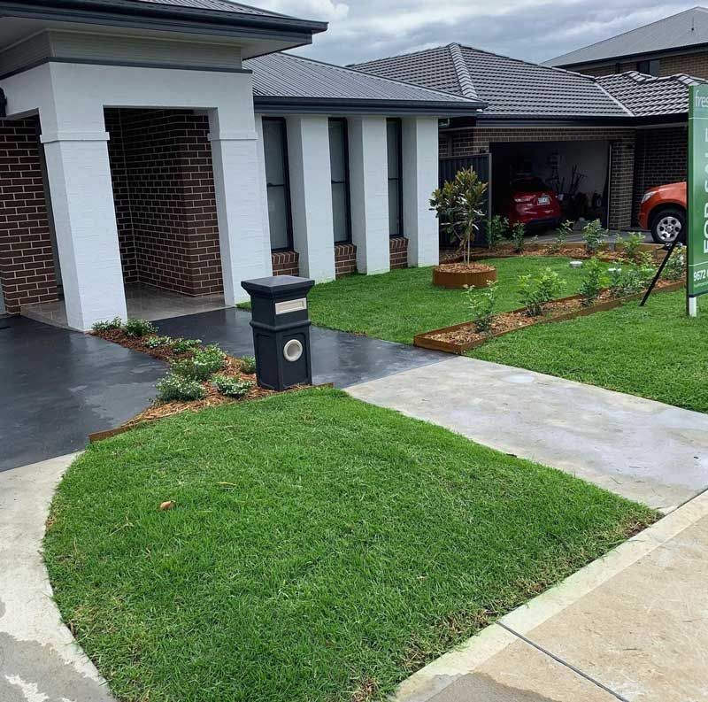 A House With a Lot of Grass in Front of It — Illawarra Gardening Landscapes in Blackbutt, NSW