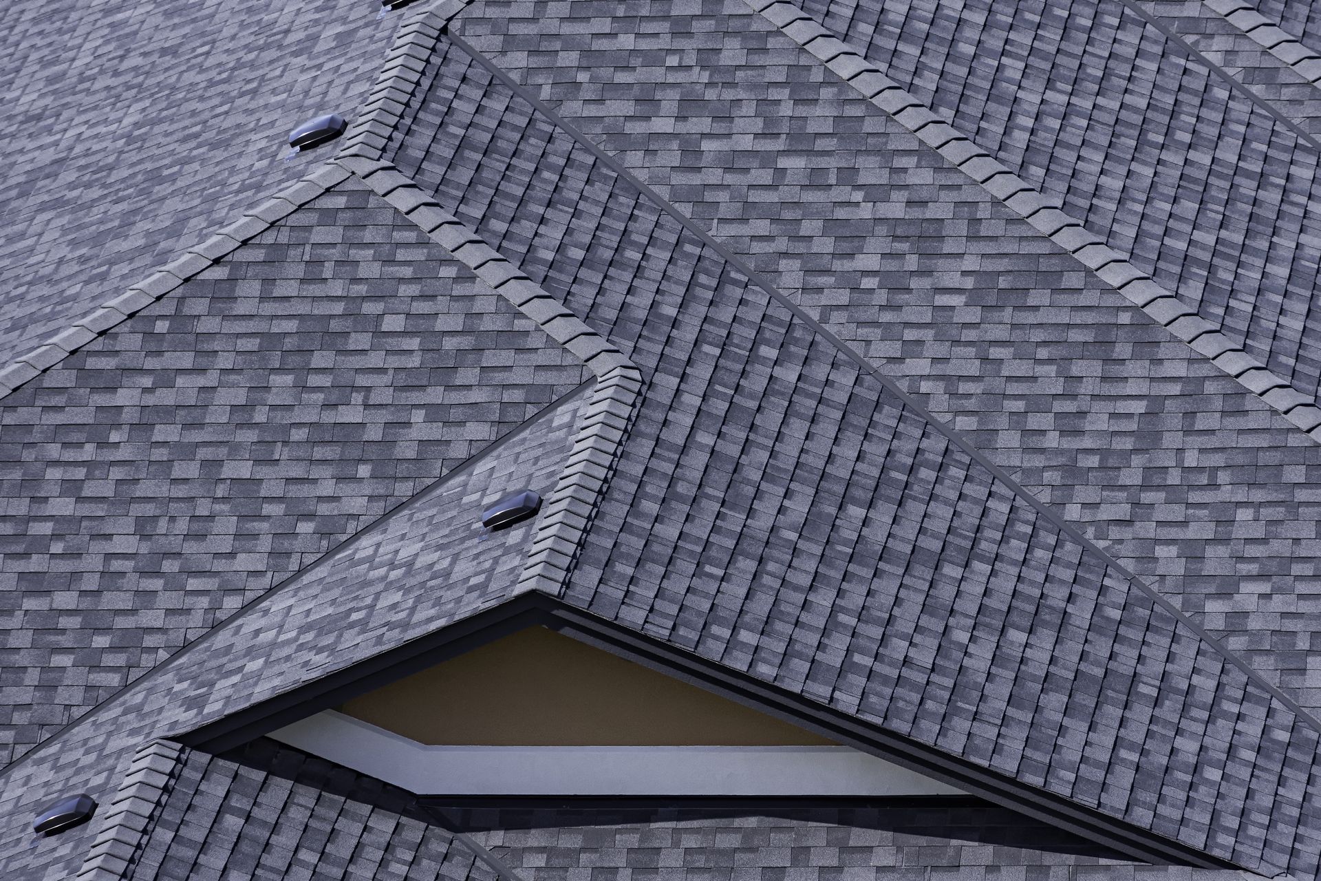 A close up of a roof with a window on it.