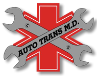 A logo for auto trans m.d. with two wrenches