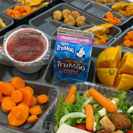 a tray of food with a carton of trumoo milk