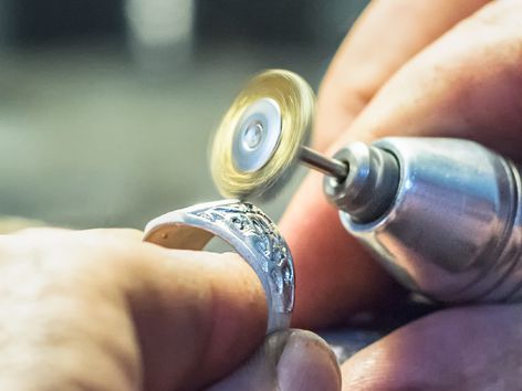 A security guard is holding a flashlight in front of a staircase.
