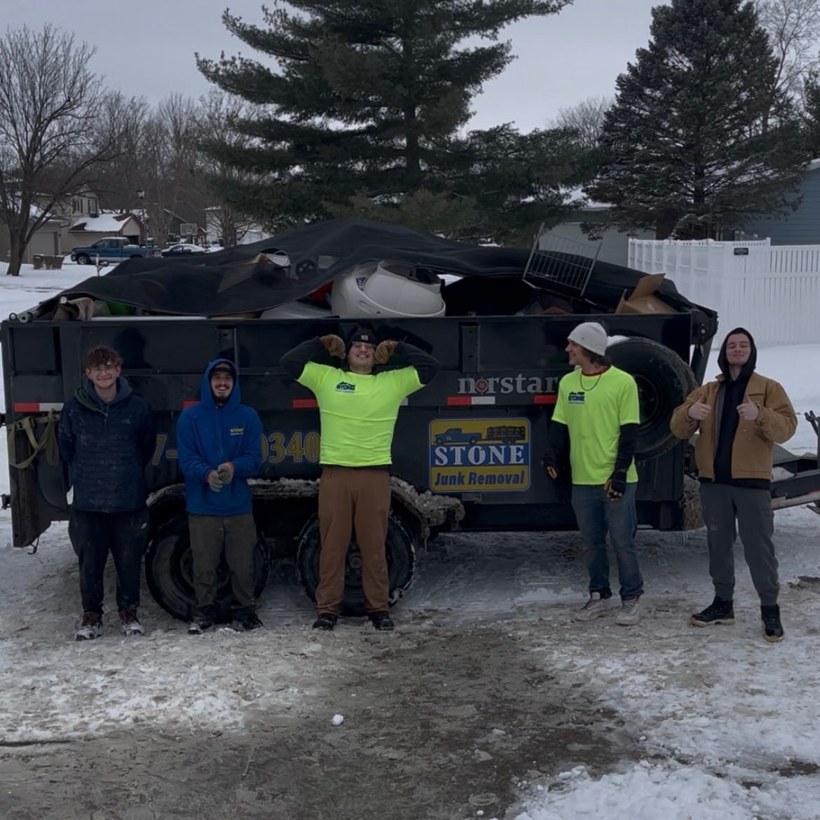 A group of people standing in front of a truck that says stone