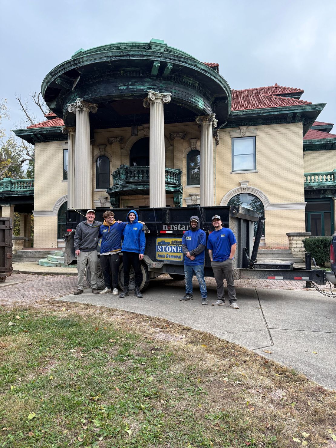 A man is carrying a bag of rubble on a cart.
