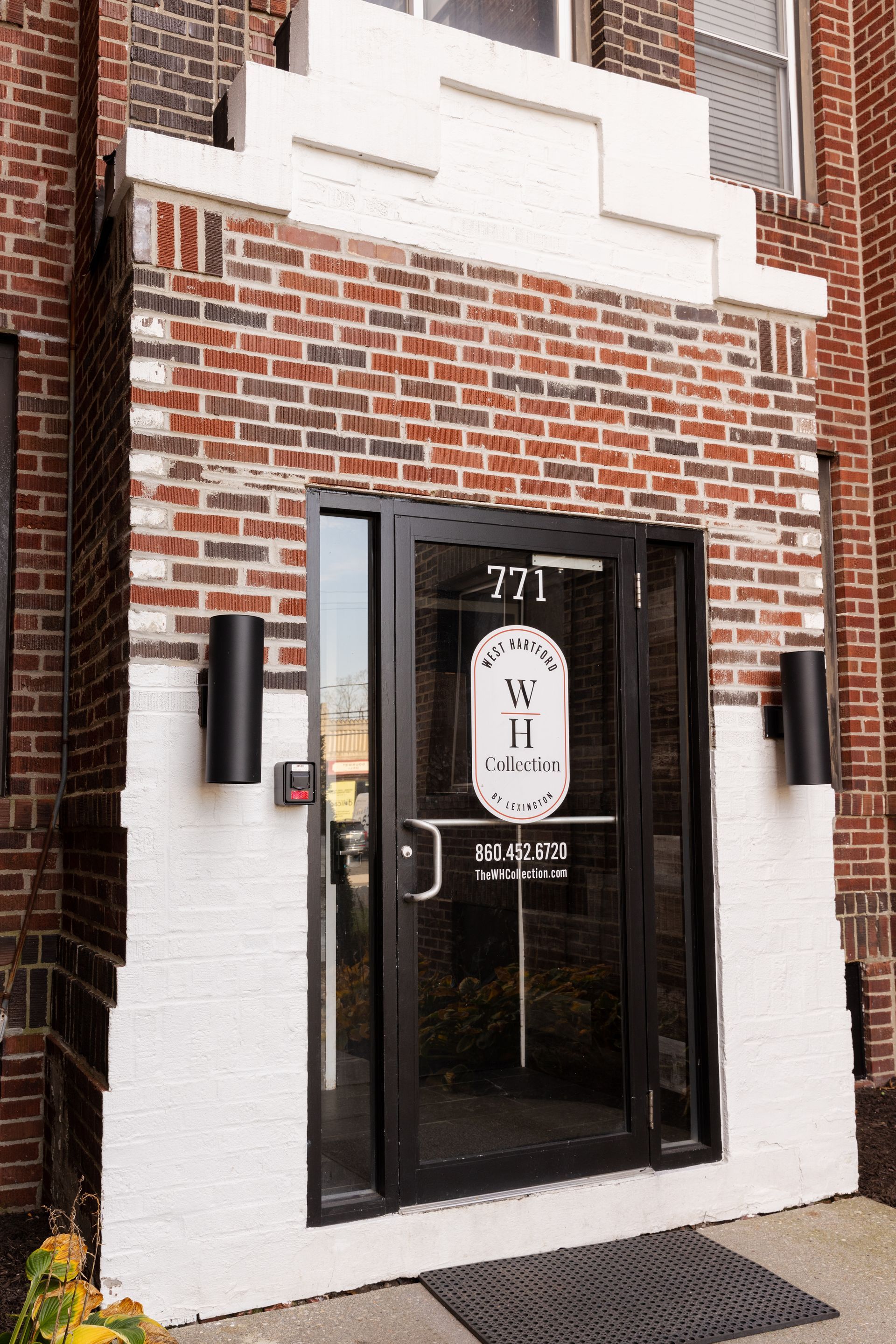 Brick entryway with black glass door, 