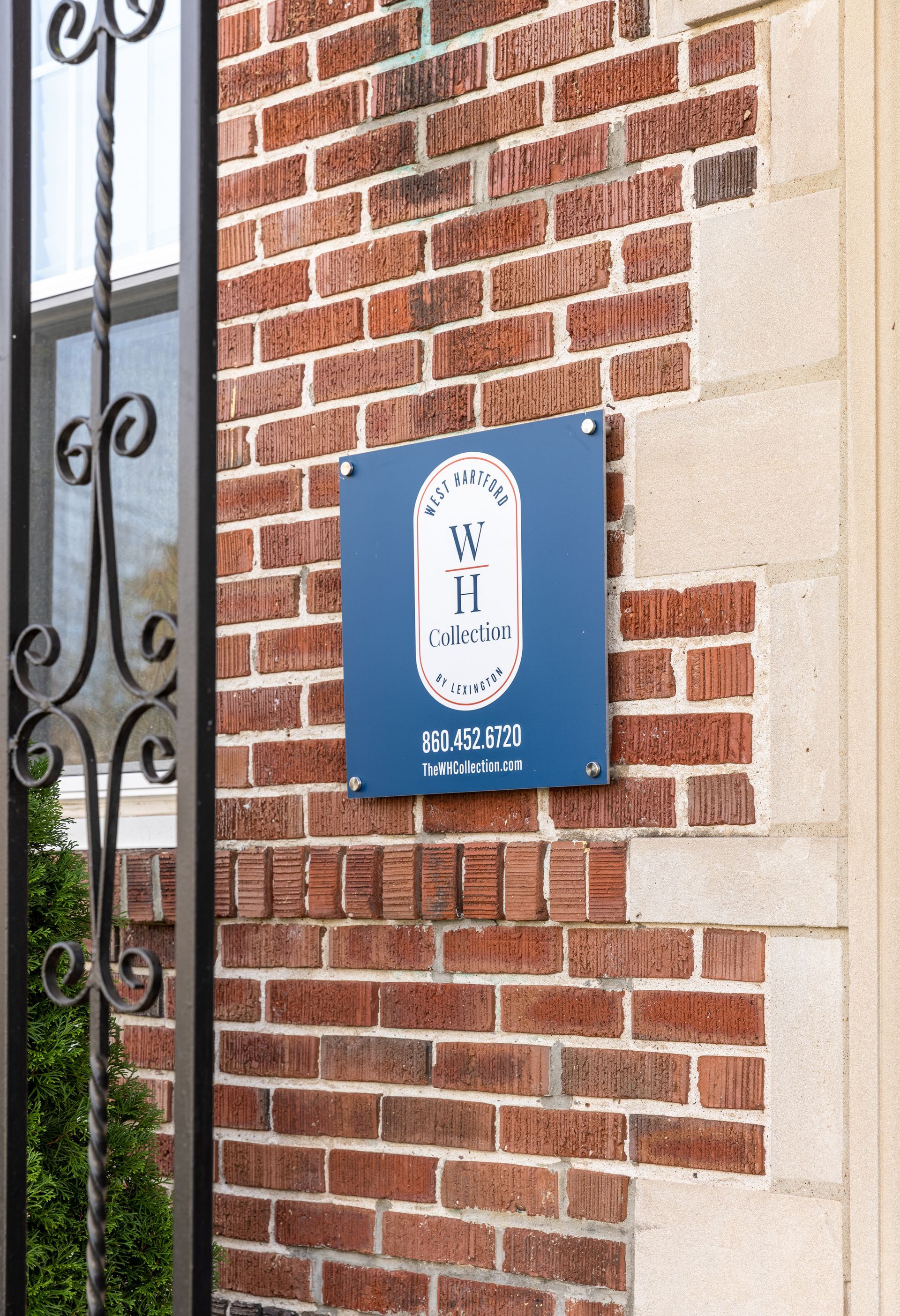 Blue sign on brick wall with 