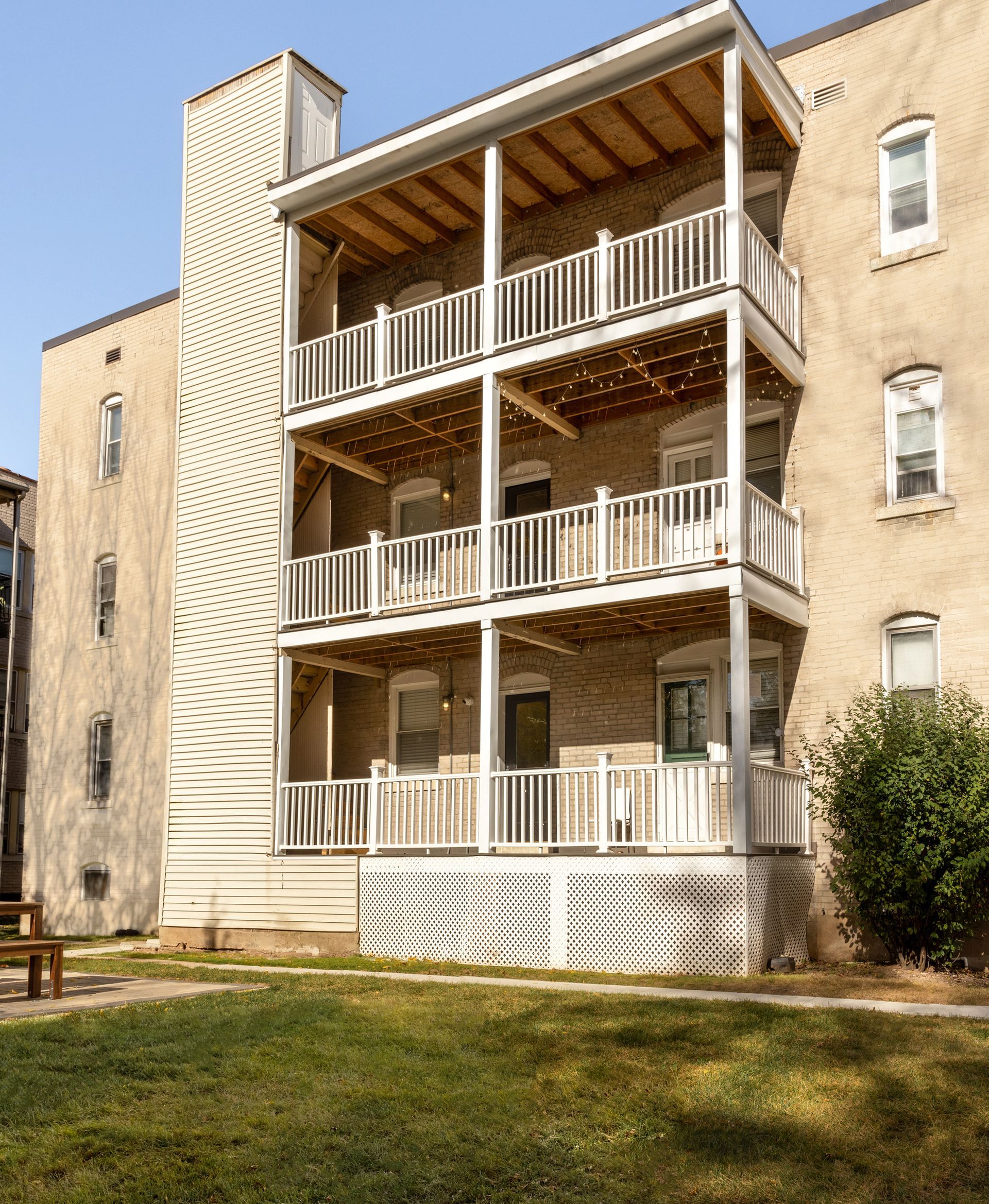 Multi-story brick building with wooden balconies.