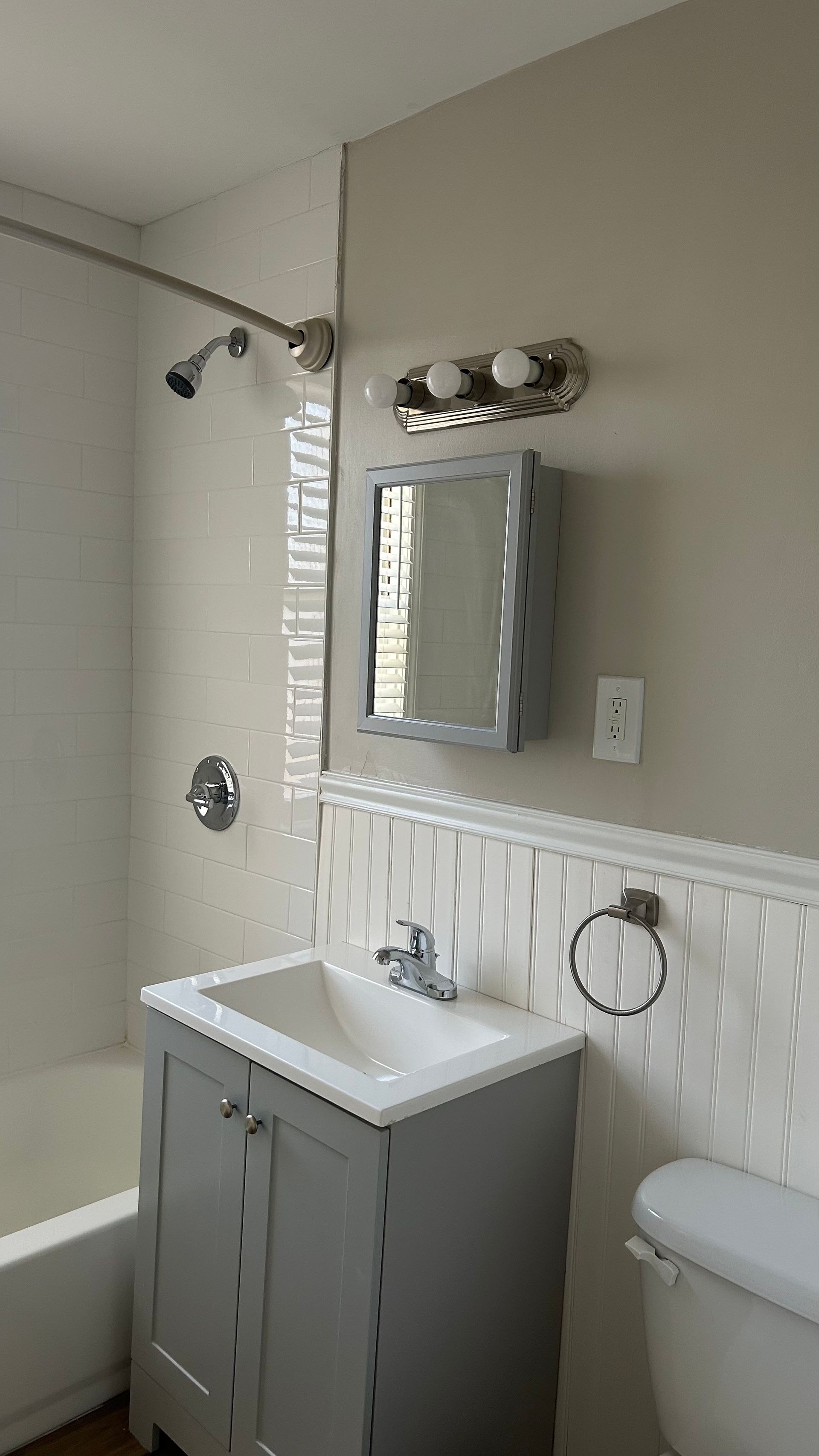 Renovated bathroom with a mirror, and shower