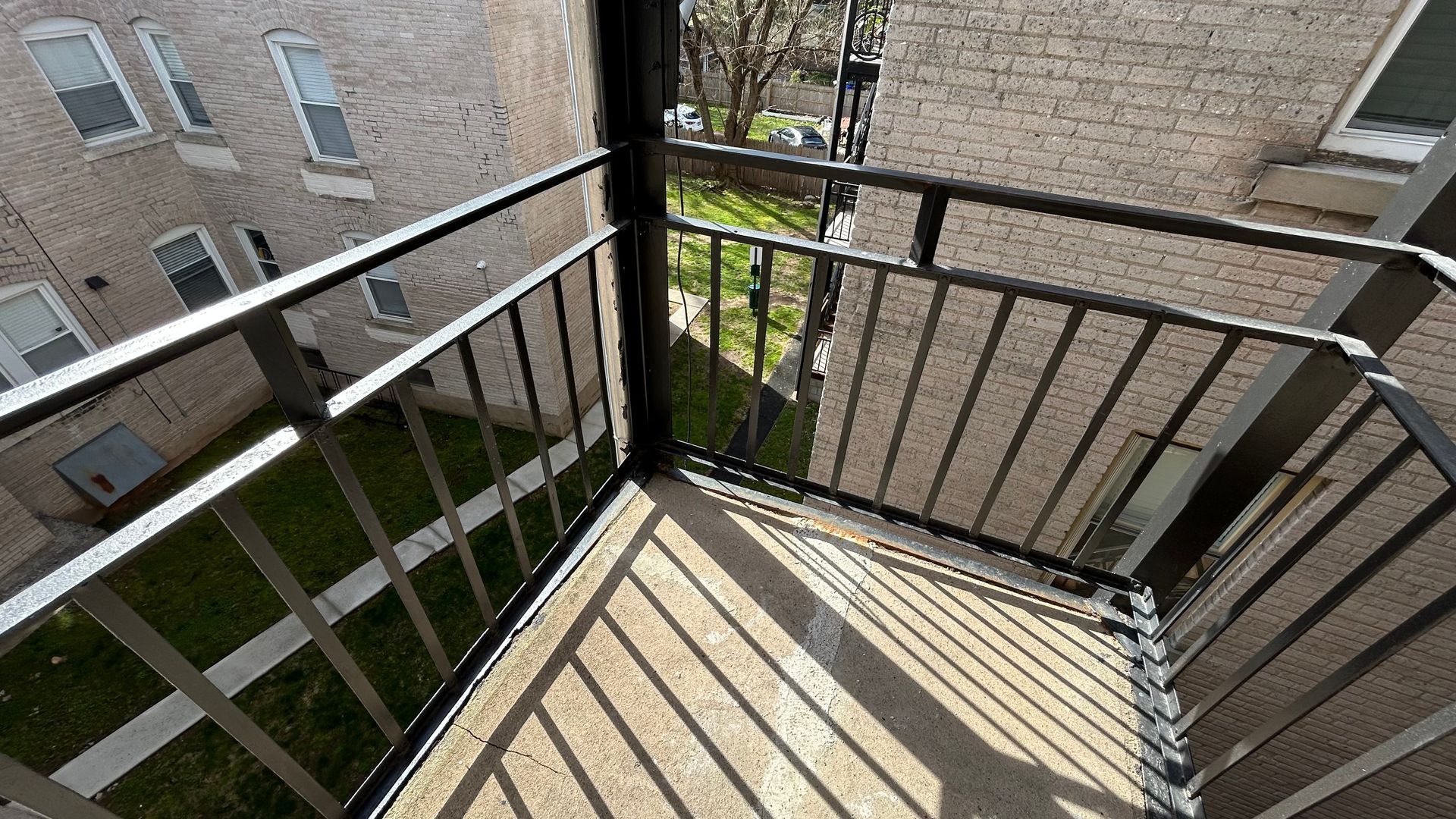 Outdoor porch / balcony area with black fencing