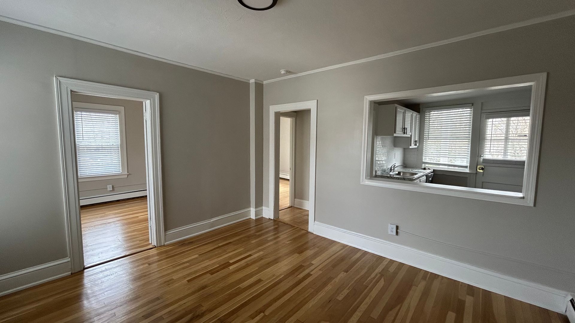 living room photo of a vintage apartment with wood floors and interior windows