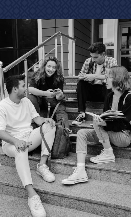 A man is fixing a sink in a kitchen in a black and white photo.