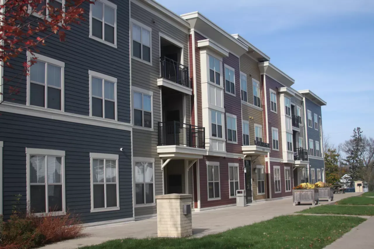 A large apartment building with a lot of windows and balconies.