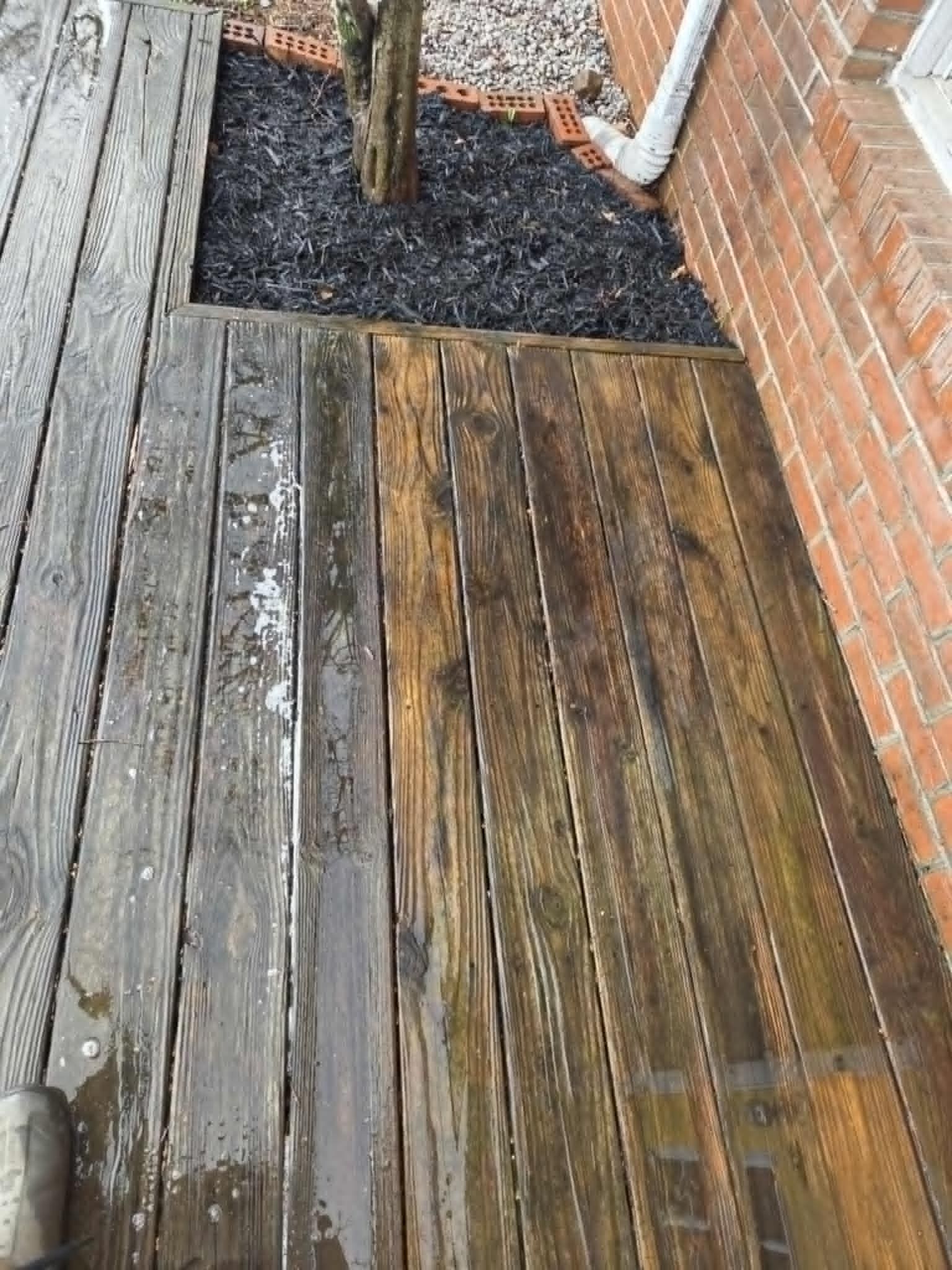 A man is cleaning a window with a squeegee.