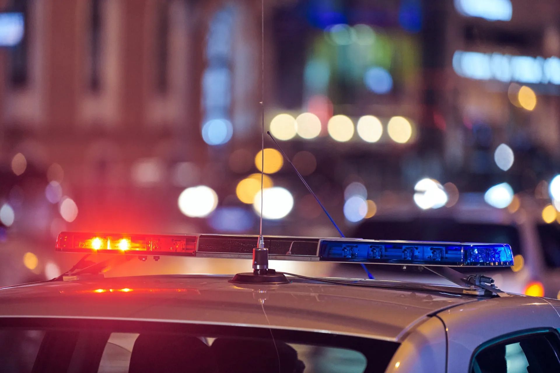 Police Car On City Street At Night — Criminal Law Firm In Brisbane, QLD