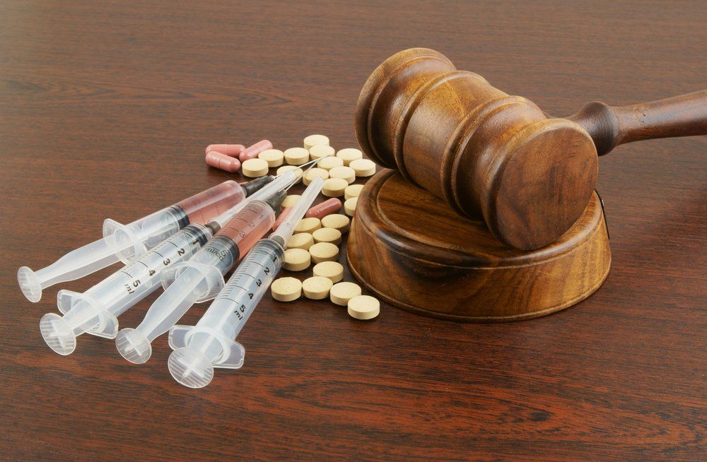 Wooden Gavel With Drugs And Syringes On Table — Criminal Law Firm In Brisbane, QLD