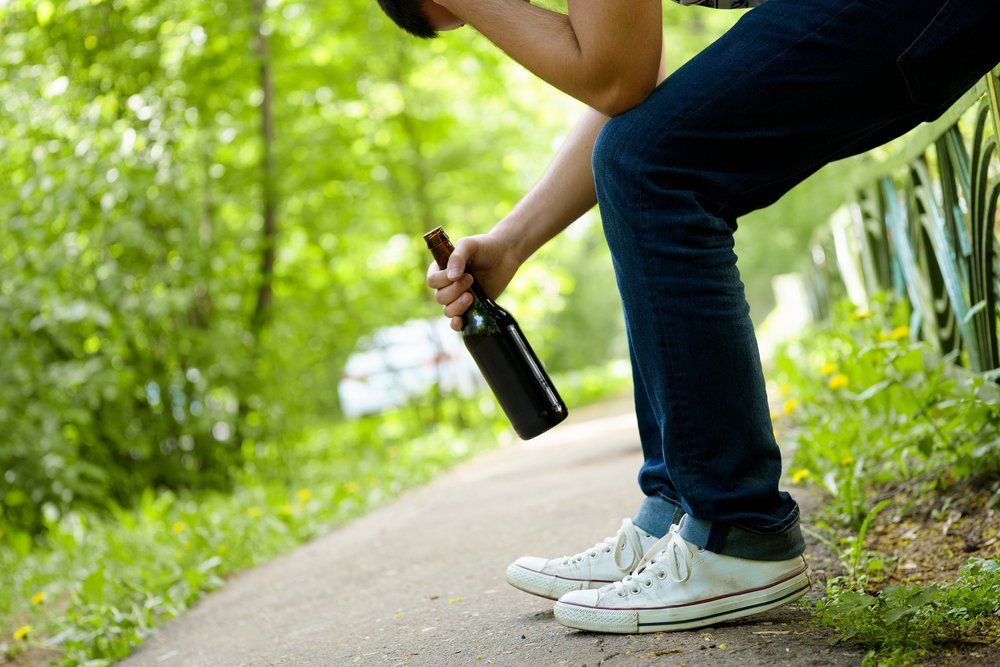 Man Holding Beer Bottle In Public — Criminal Law Firm In Brisbane, QLD