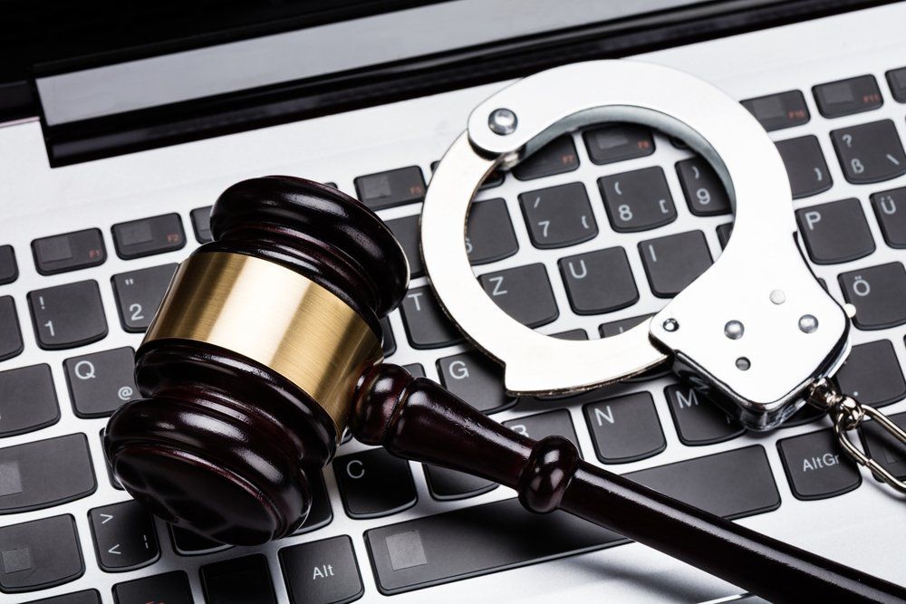 Judge's Gavel and Handcuffs On A Computer Keyboard — Criminal Law Firm In Brisbane, QLD