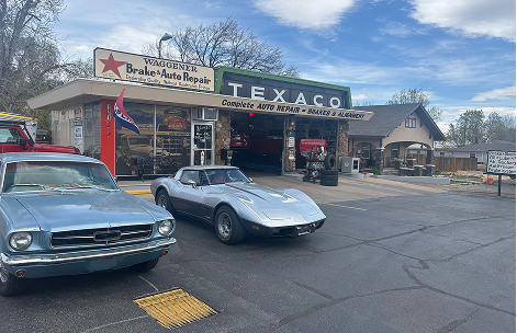 A silver vintage Corvette and a light blue Ford Mustang parked in front of a Texaco service station on a sunny day. | Waggener Brake and Auto Repair