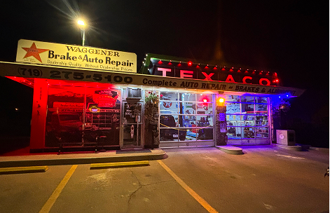 Night view of Waggoner Brake & Auto Repair, an auto shop featuring red and blue neon signs and a Texaco sign. | Waggener Brake and Auto Repair