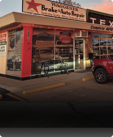 Waggener Brake & Auto Repair storefront with a red, white, and black design and a red truck parked in front. | Waggener Brake and Auto Repair