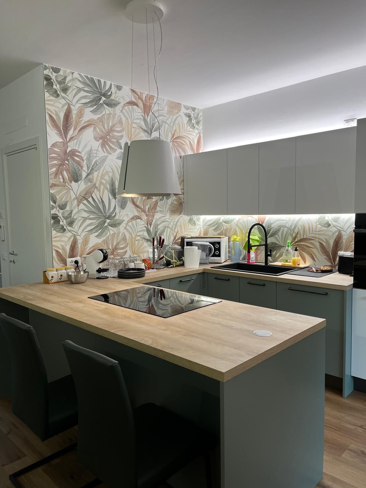 Una cucina con una grande isola e un forno con piano cottura.