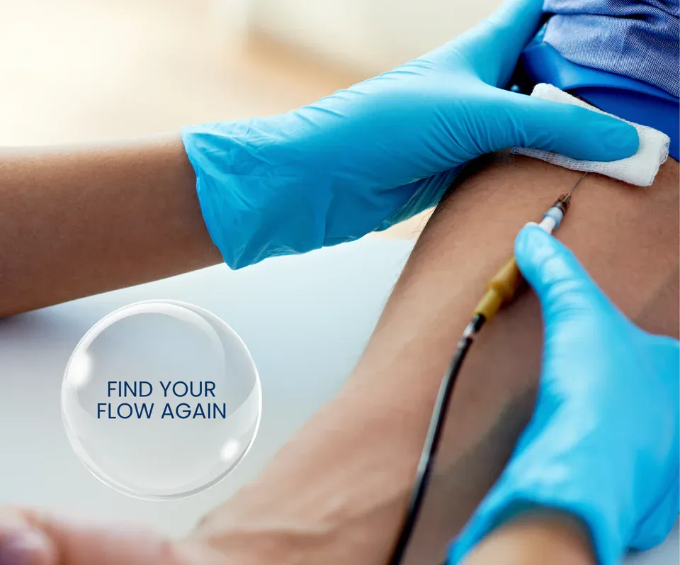 Medical professional in blue gloves drawing blood from a patient's arm;