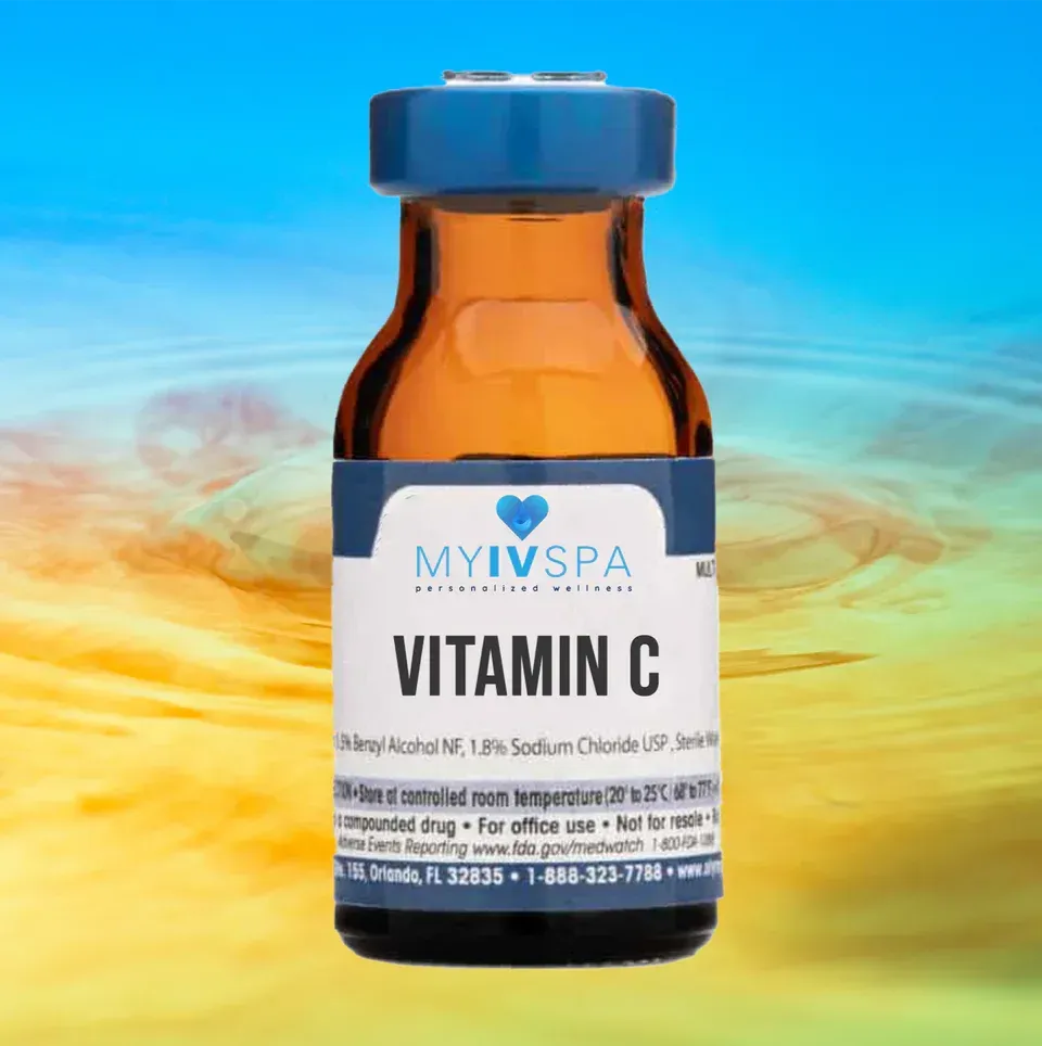 Vial of Vitamin C for IV infusion. Amber glass bottle with blue cap and label, against a yellow/blue background.