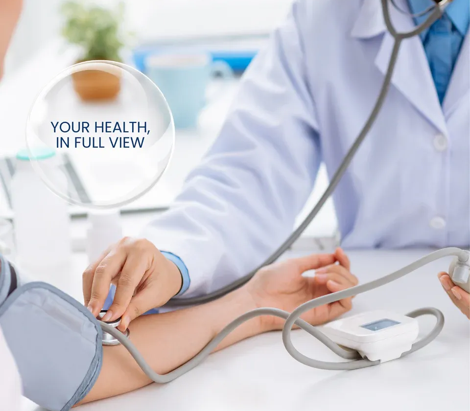 Doctor taking patient's blood pressure with stethoscope and cuff in an office setting. Text bubble reads: