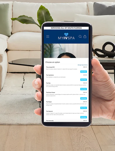 Hand holding phone displaying a spa menu in a home setting.