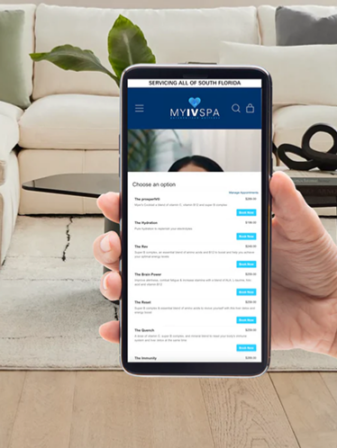 Hand holding phone displaying a spa menu in a home setting.