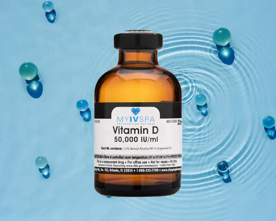 Amber bottle of Vitamin D, 50,000 IU/ml, with label against a blue water background with scattered blue orbs.