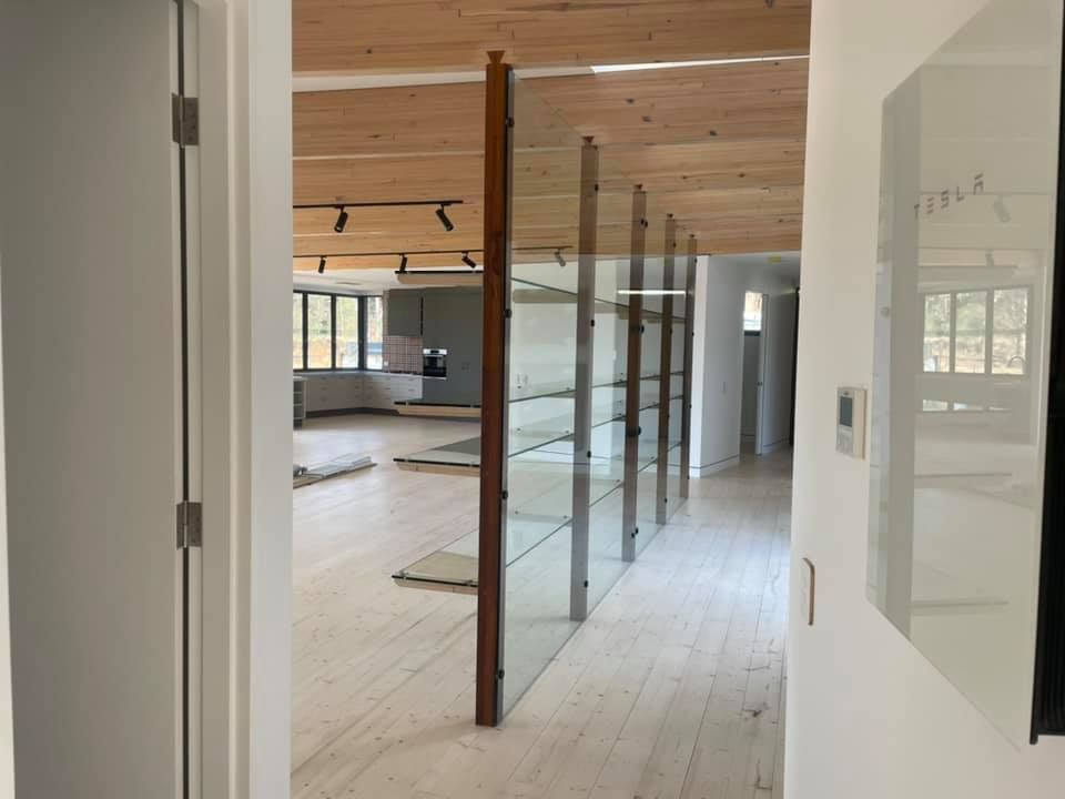 A hallway in a house with a wooden ceiling and a glass wall — GGS Alice Glass & Aluminium In Ciccone, NT