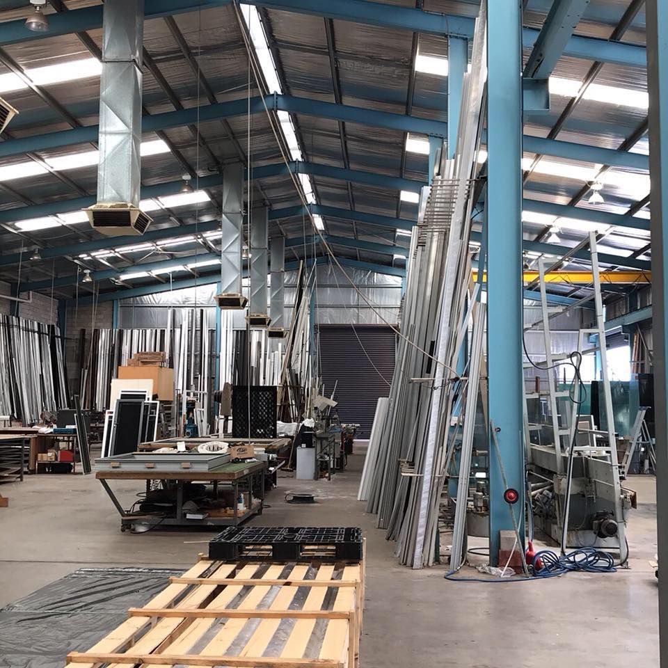 A Large Warehouse Filled With Lots Of Metal Pallets — GGS Alice Glass & Aluminium In Ciccone, NT