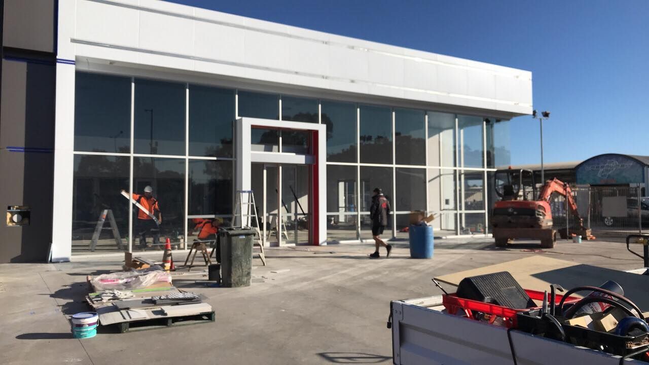 A Large Building With A Lot Of Windows Is Being Built — GGS Alice Glass & Aluminium In Ciccone, NT