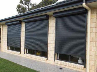 A House With Three Windows With Black Roller Shutters On Them — GGS Alice Glass & Aluminium In Ciccone, NT