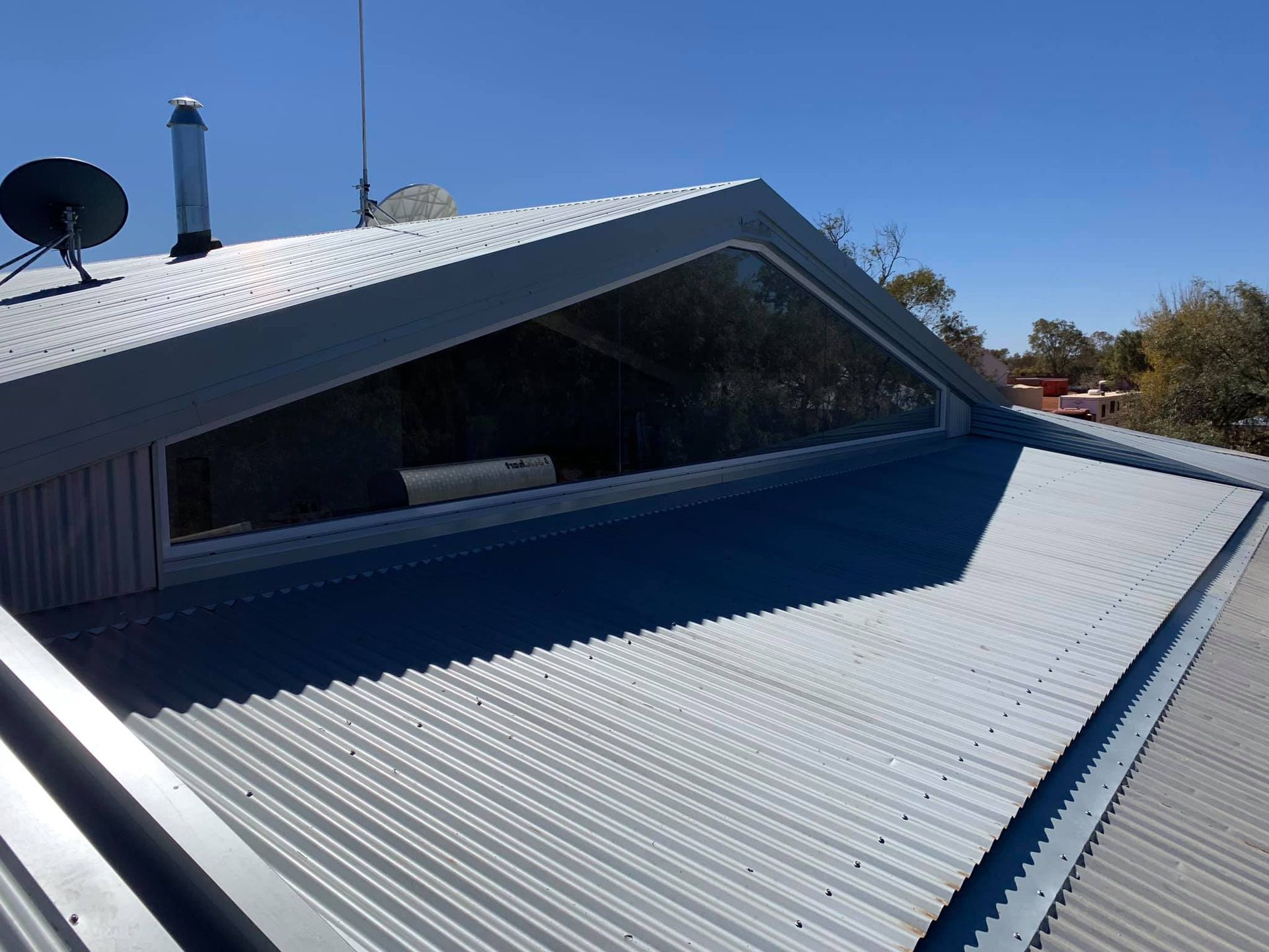 A Roof With A Window And A Satellite Dish On Top Of It — GGS Alice Glass & Aluminium In Ciccone, NT