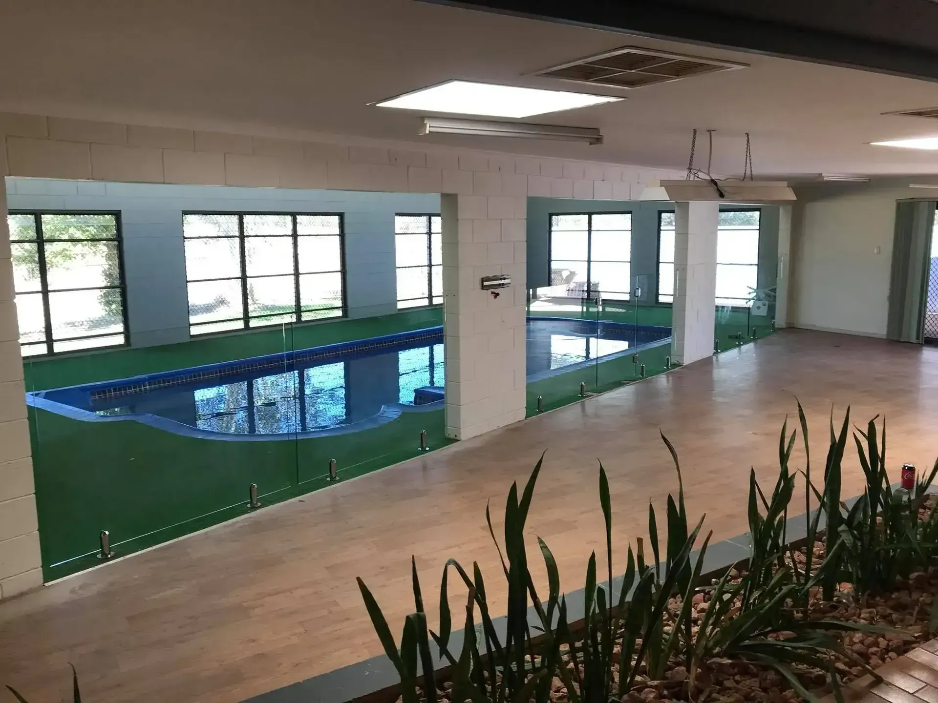 A Large Room With A Swimming Pool And Glass Divider — GGS Alice Glass & Aluminium In Ciccone, NT