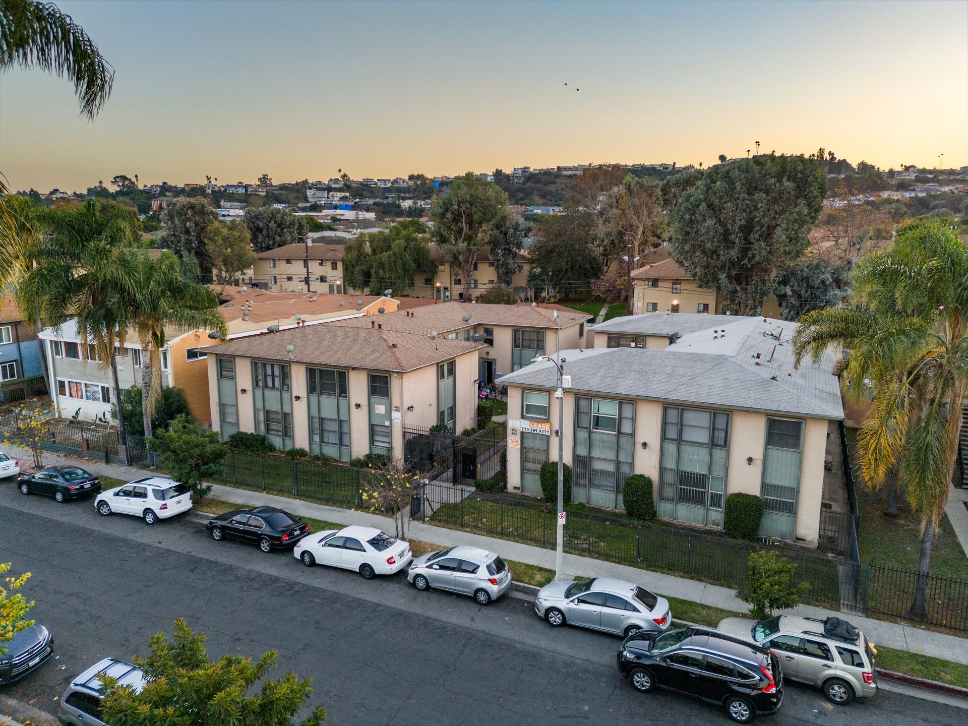 a row of apartment buildings with the sun shining through the windows