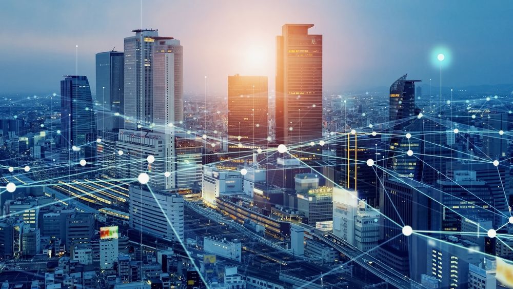 An aerial view of a city at night with a lot of buildings connected to each other.