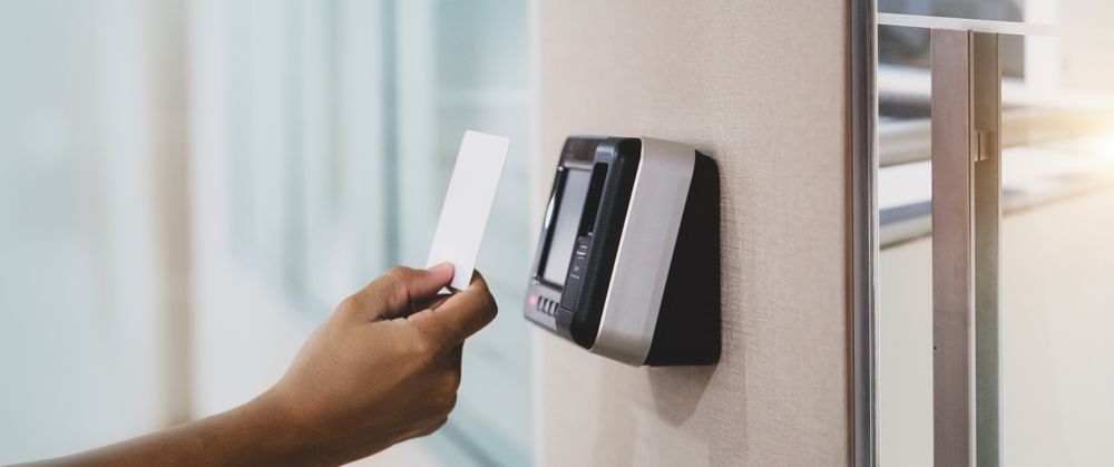 A person is using a smart card to open a door.