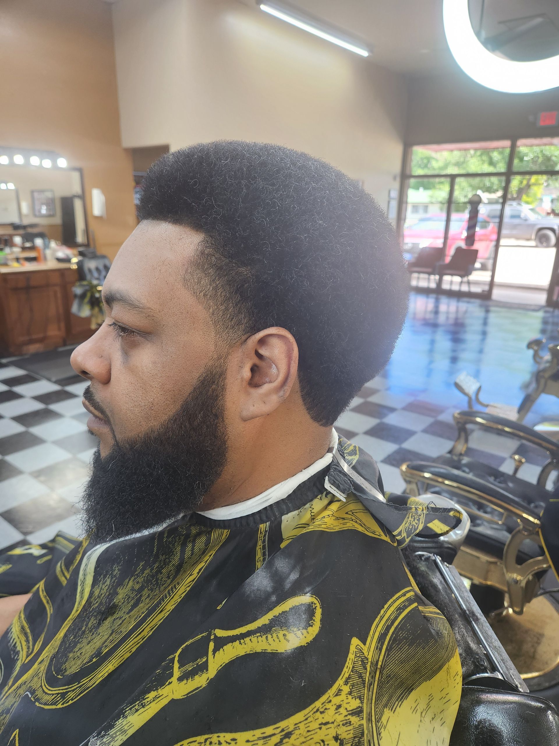 A man is getting his hair cut in a barber shop