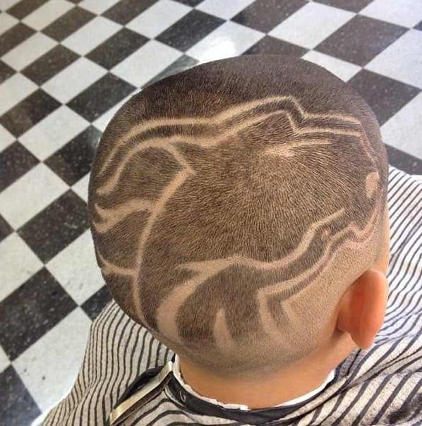 A young boy with a shaved design on his head