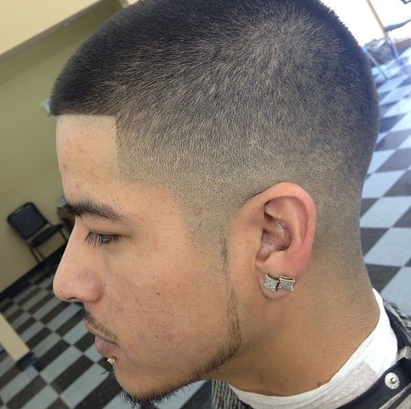 A close up of a man 's ear with a butterfly earring