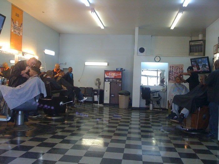 A man is getting his hair cut in a barber shop